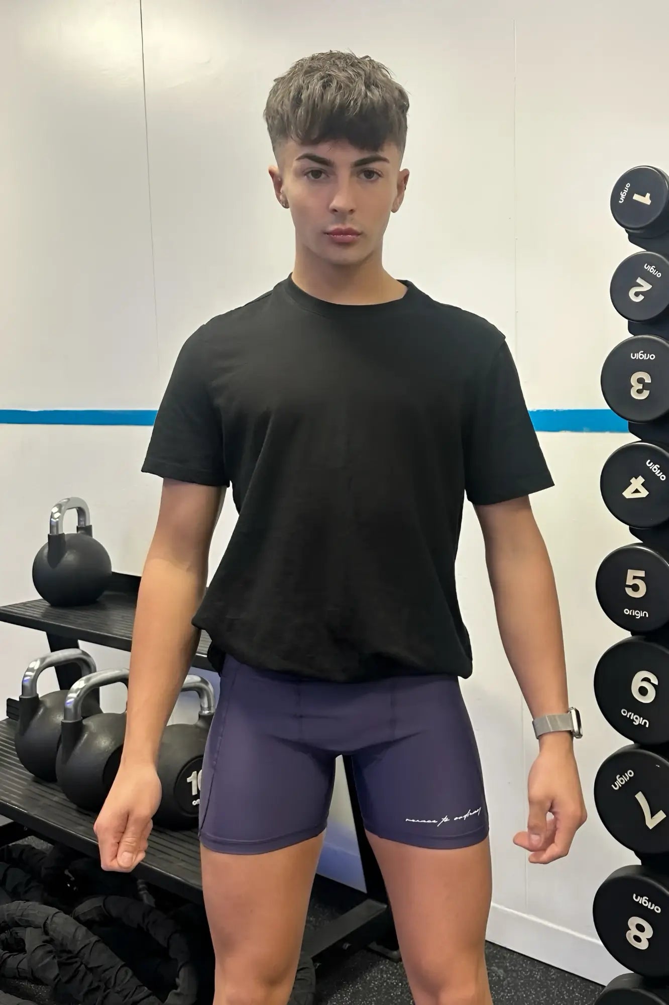 Navy blue lustrous scrunch-butt 45 inch bike shorts with subtle white logo on lower left leg in sugar plum color
