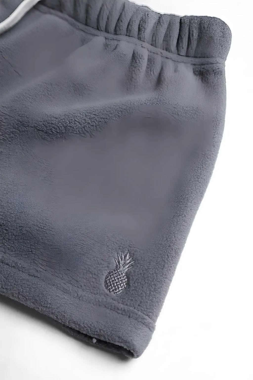 Gray luxe plush fleece 2 inch short shorts with small embroidered pineapple logo on the lower leg