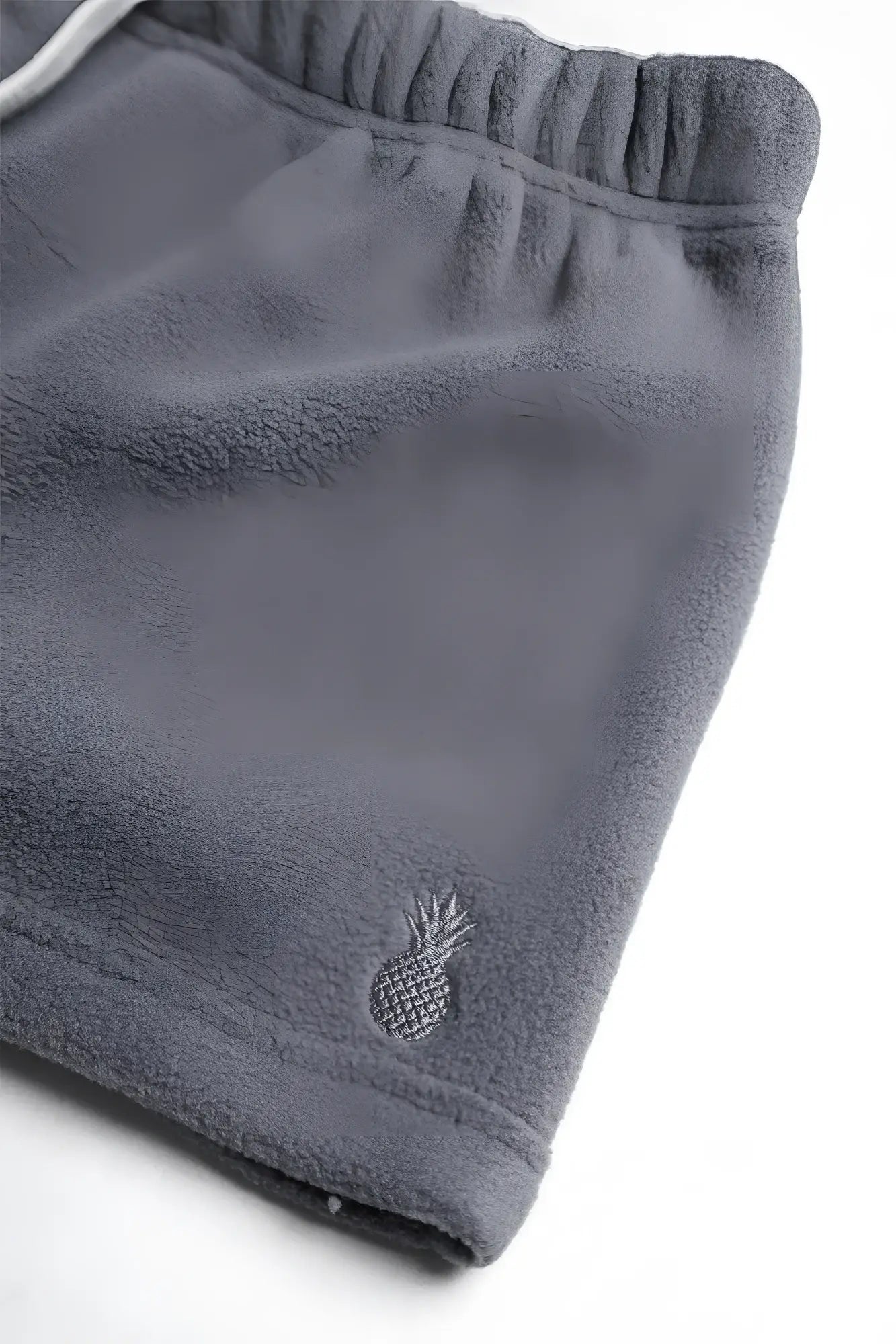 Gray luxe plush fleece 2 inch short shorts with small embroidered pineapple logo on the lower leg