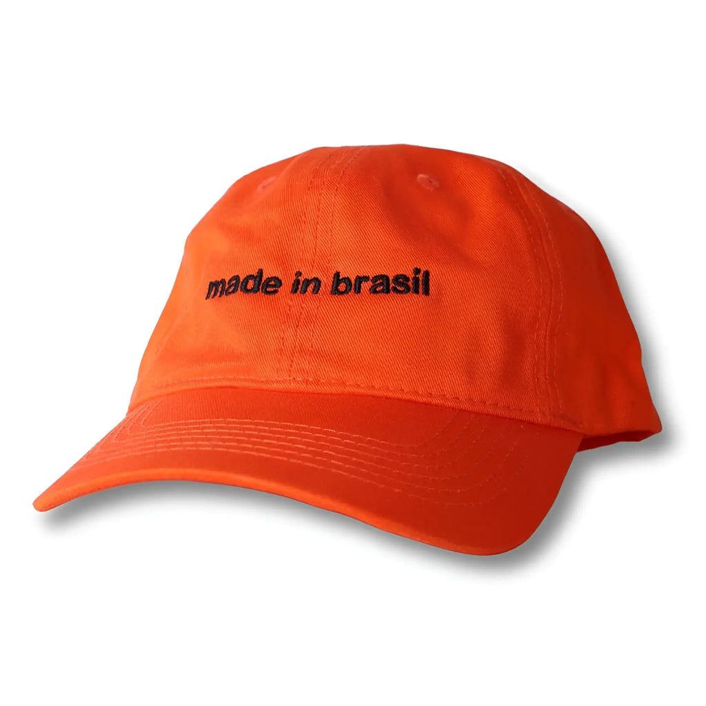Bright orange cotton dad hat with black embroidered made in brasil text across the front