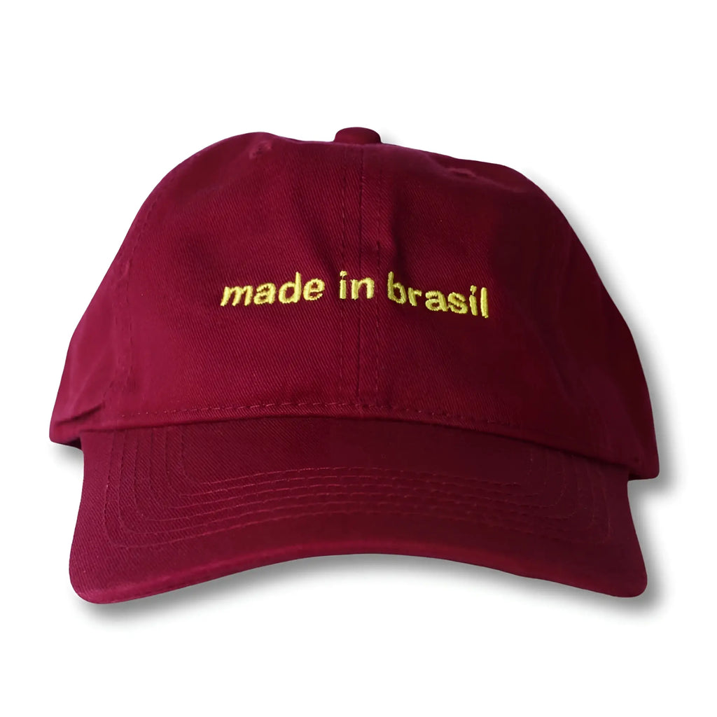 Maroon dad hat with gold embroidered made in brasil text featuring adjustable back strap for casual wear