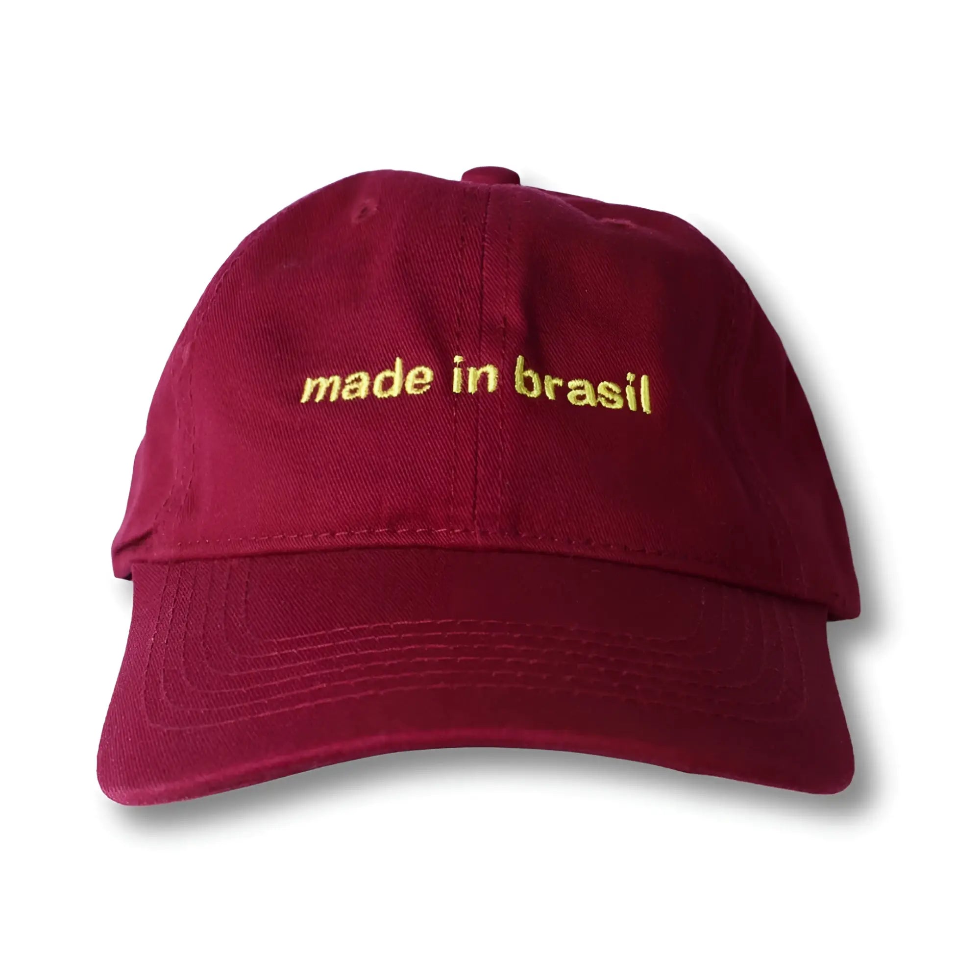 A maroon dad hat with gold embroidered made in brasil text on the front perfect for casual wear