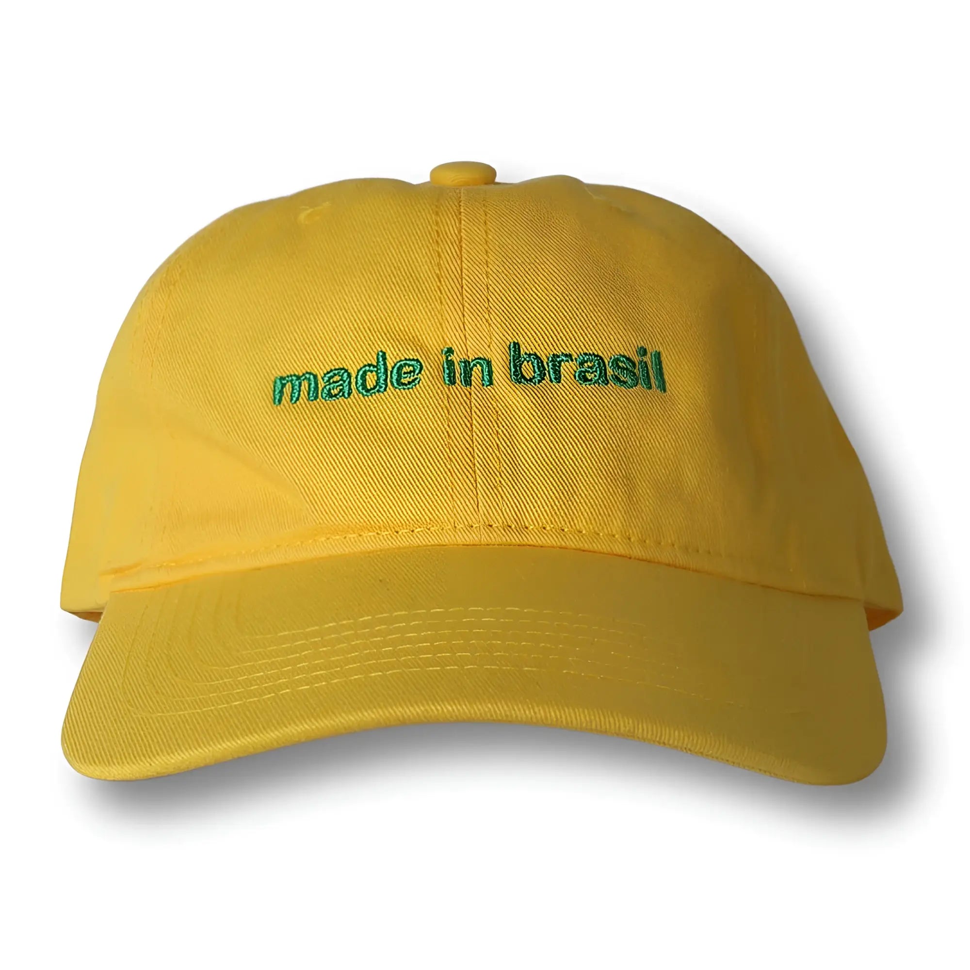 Yellow dad hat with green embroidered made in brazil text featuring adjustable strap at the back