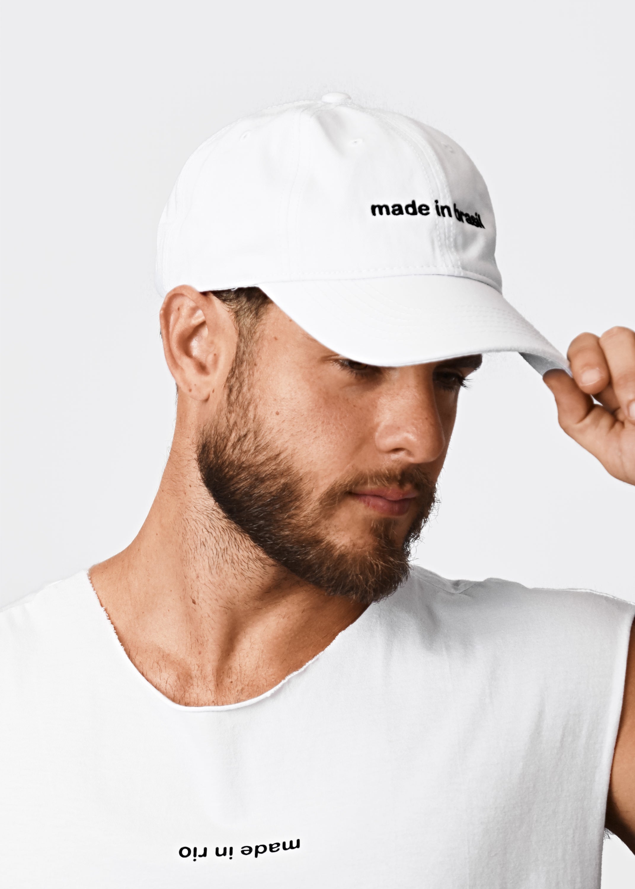 White dad hat with black embroidered made in brazil text on front for casual wear