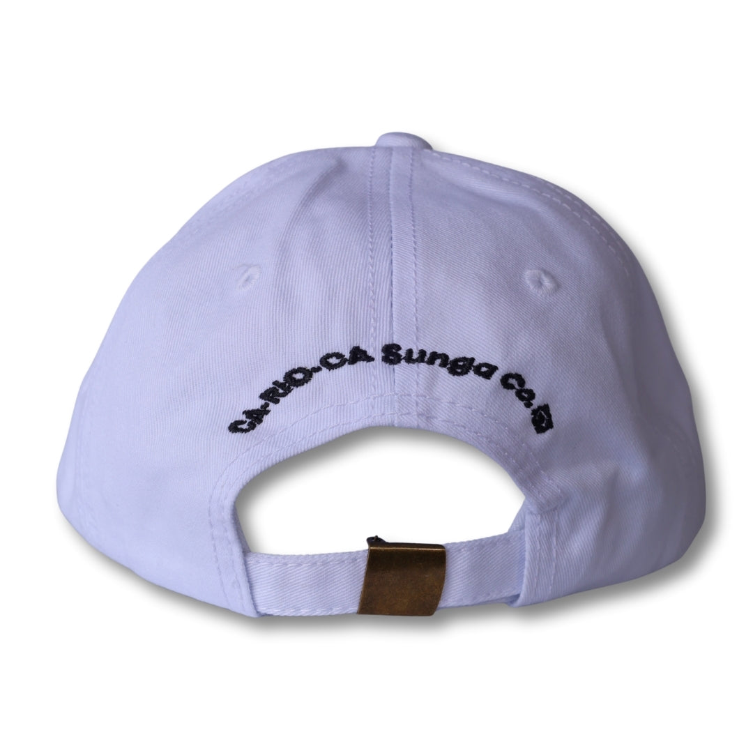 White dad hat made in brasil with black embroidered text and gold-tone metal adjustment strap at the back