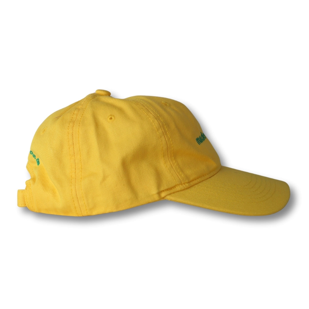 A vibrant yellow dad hat with subtle green embroidered branding made in brasil perfect for casual wear
