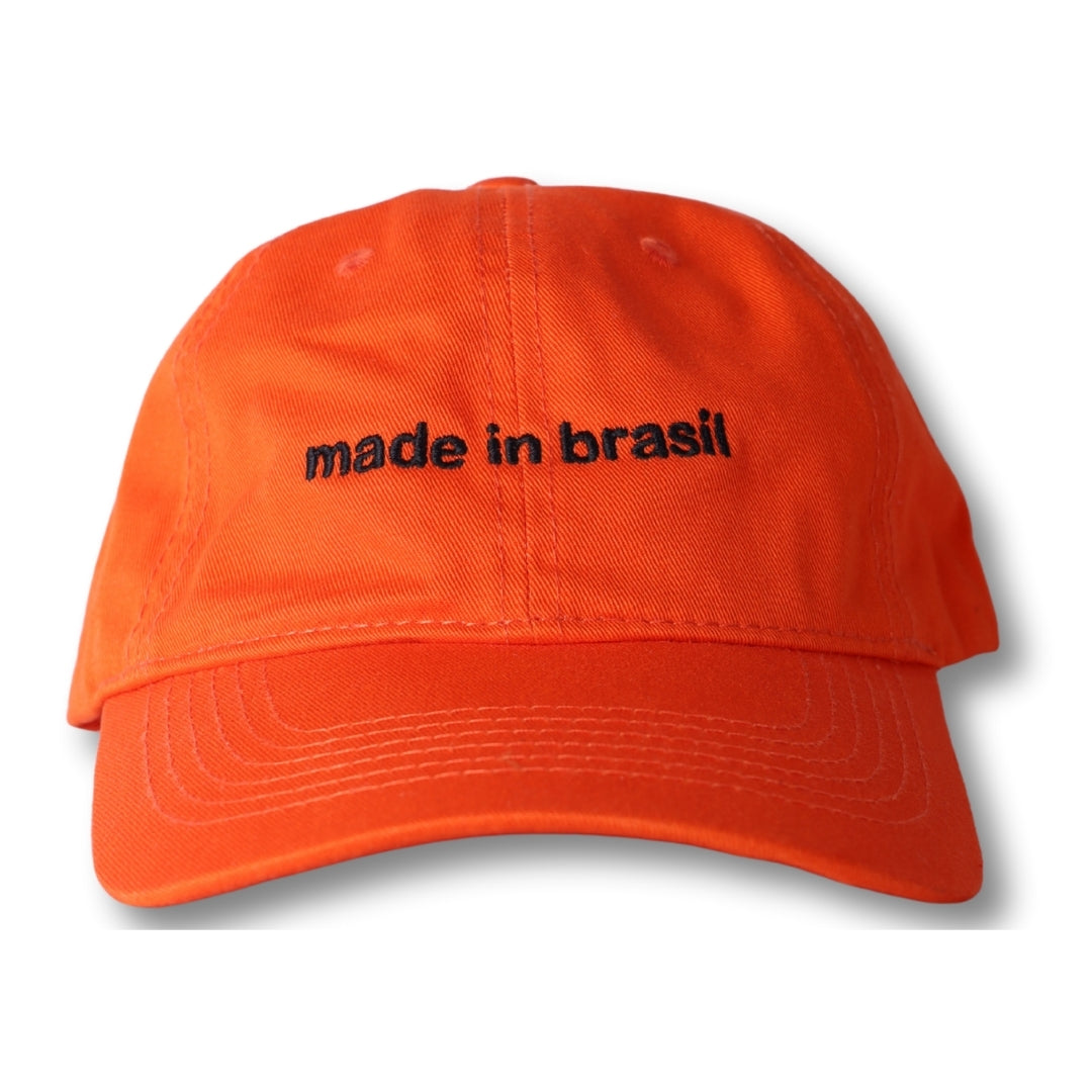 Bright orange made in brasil dad hat with black embroidered text on front for casual wear