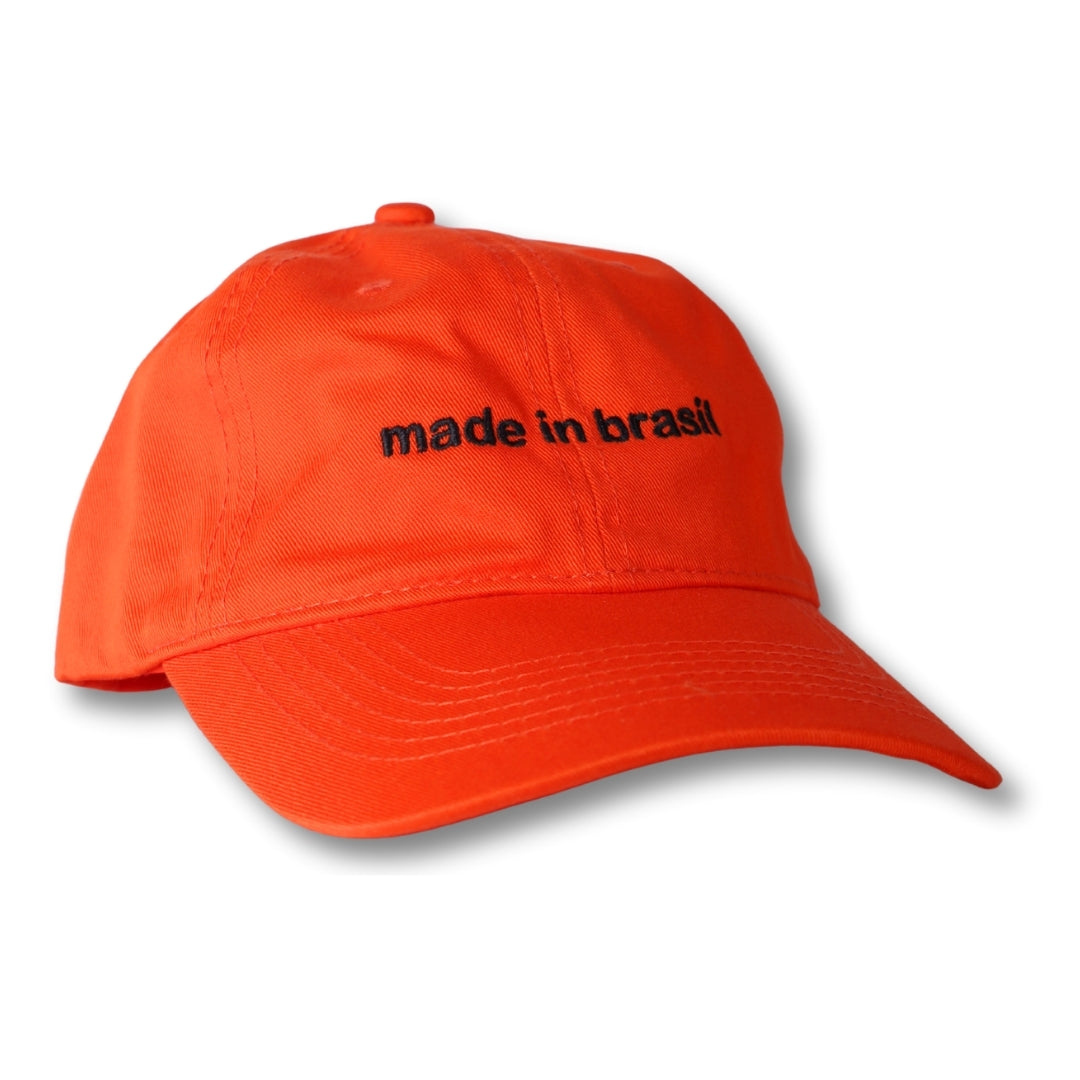 Bright orange dad hat with black embroidered made in brasil text on front perfect for casual wear