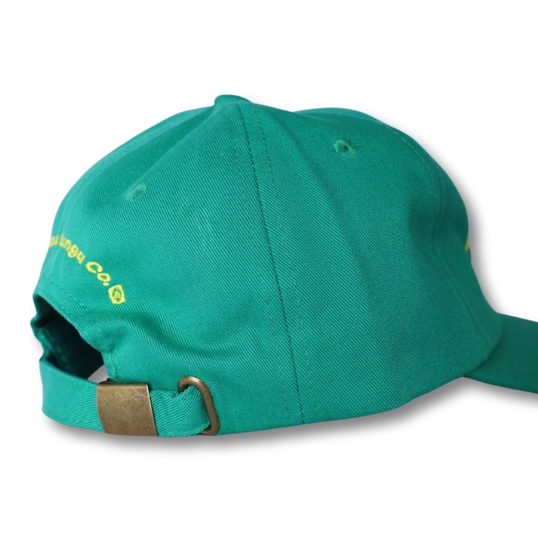 Teal cotton dad hat made in Brasil with yellow embroidered text and brass-colored metal buckle at the back