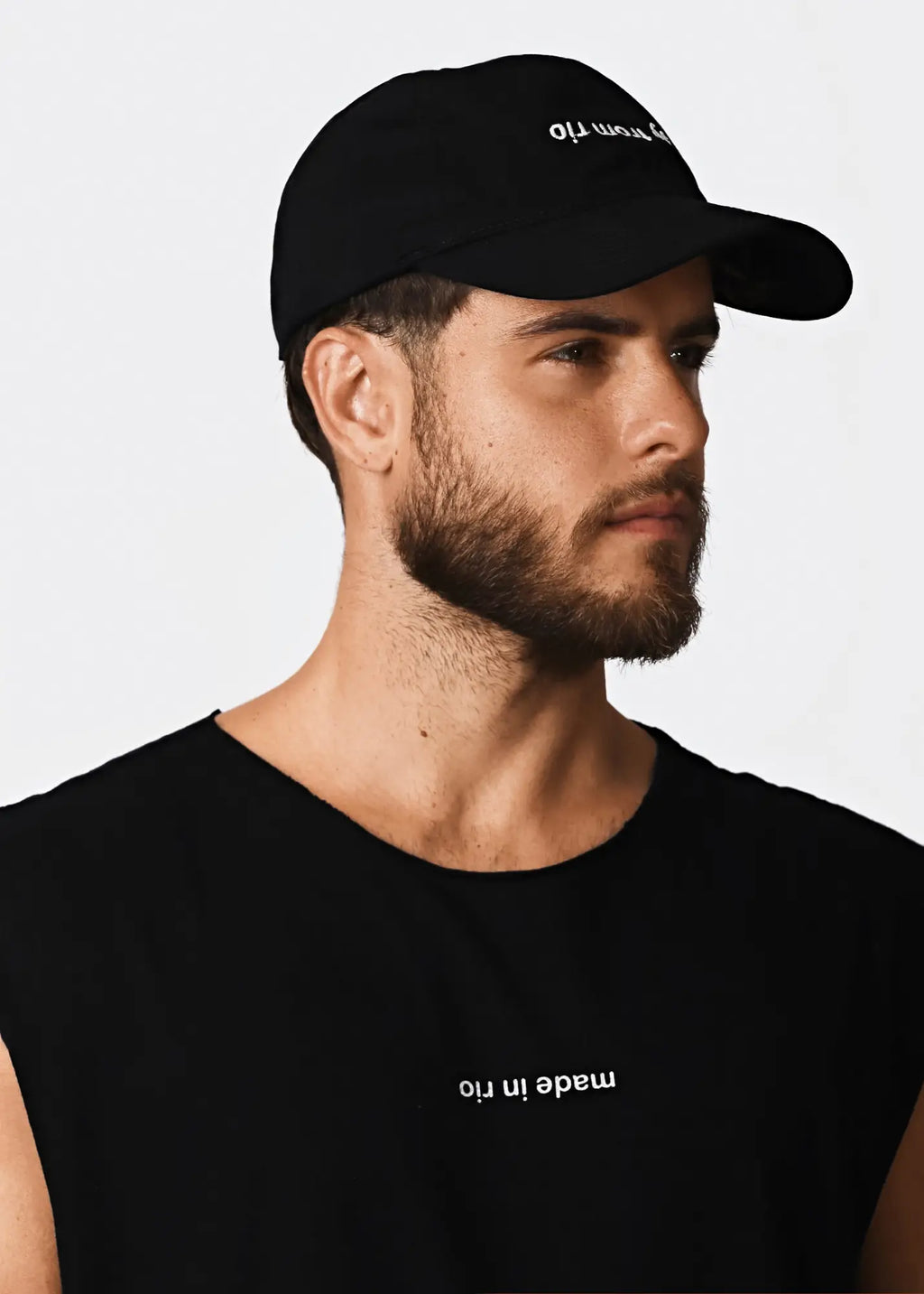 Black cotton baseball cap with white embroidered text on the front matching made in rio flip mens sleeveless t shirt