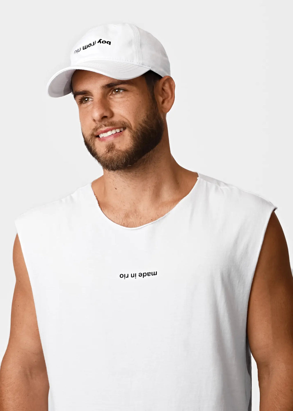 White cotton baseball cap with black embroidered boy from text shown with made in rio flip mens sleeveless t shirt