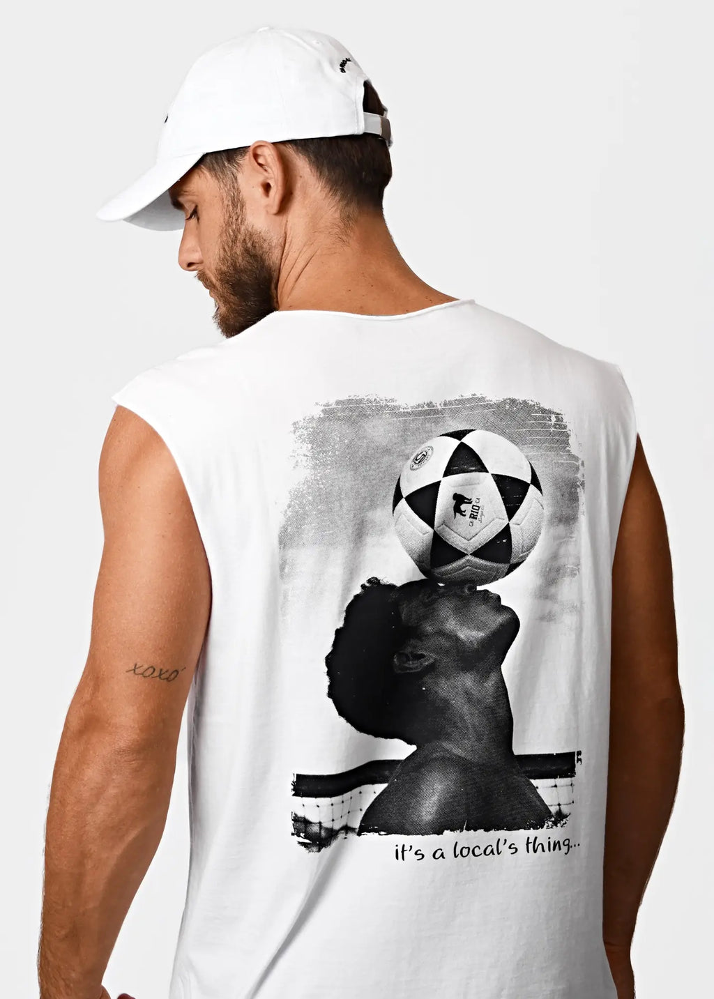 White cotton sleeveless tank top featuring a black and white graphic of a person balancing a soccer ball on their head
