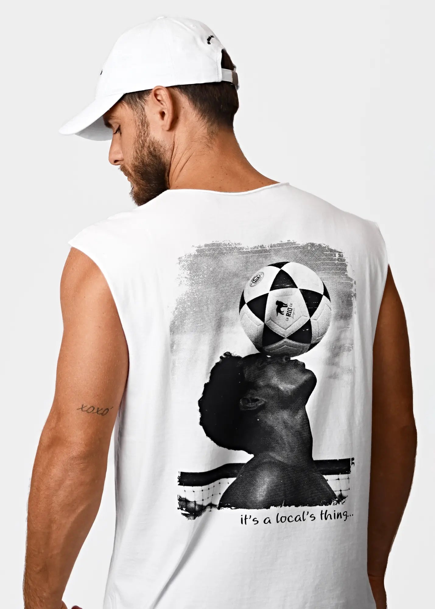 White cotton sleeveless tank top featuring a black and white graphic of a person balancing a soccer ball on their head