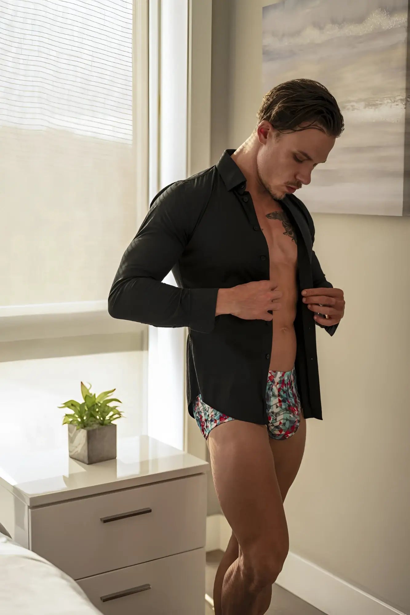 Man wearing male power 131-293 lace pouch shorts in red white blue with floral patterned underwear