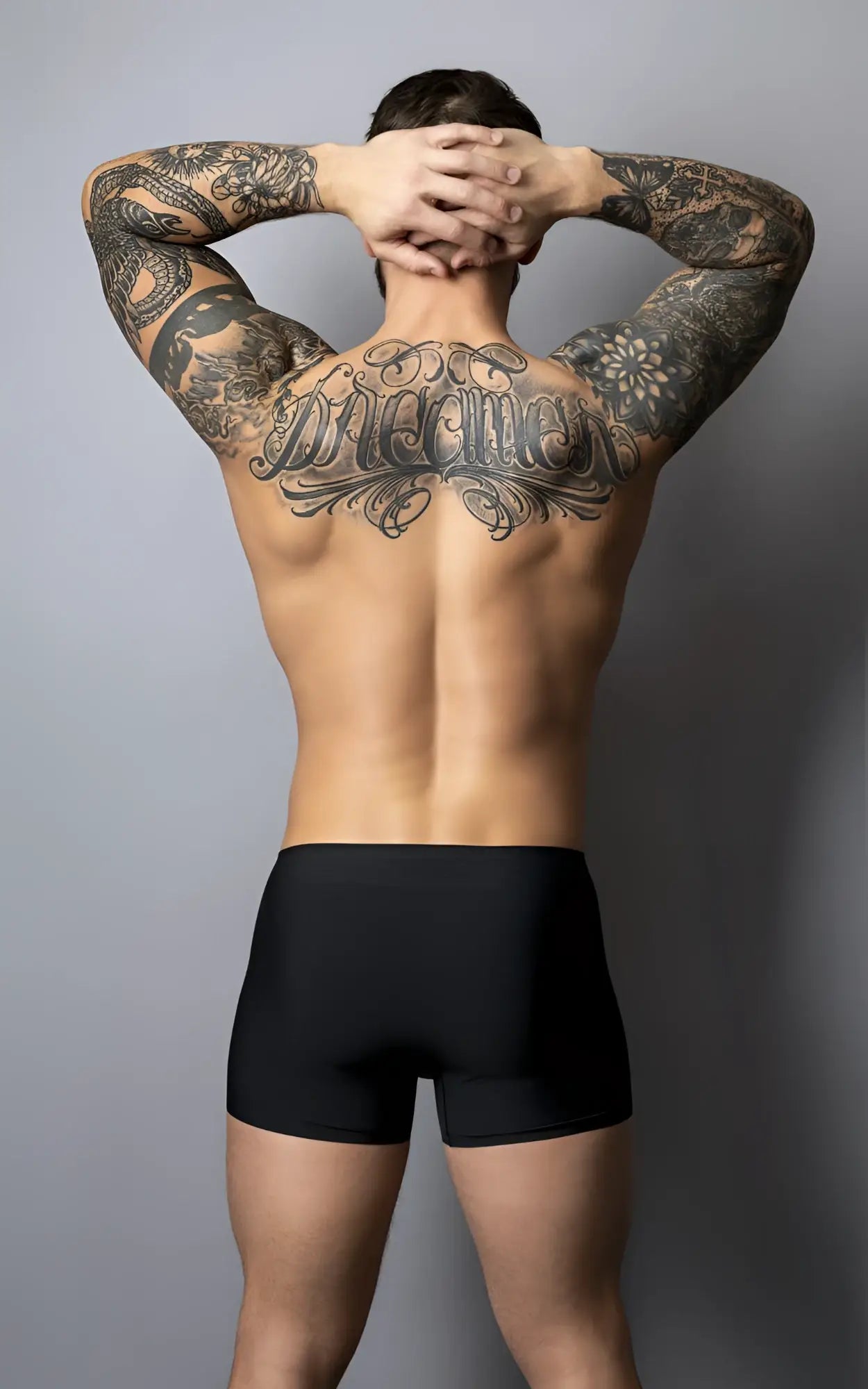 A man showing the back side of male power 154-300 hot mesh pouch short in black red with tattoos and black briefs
