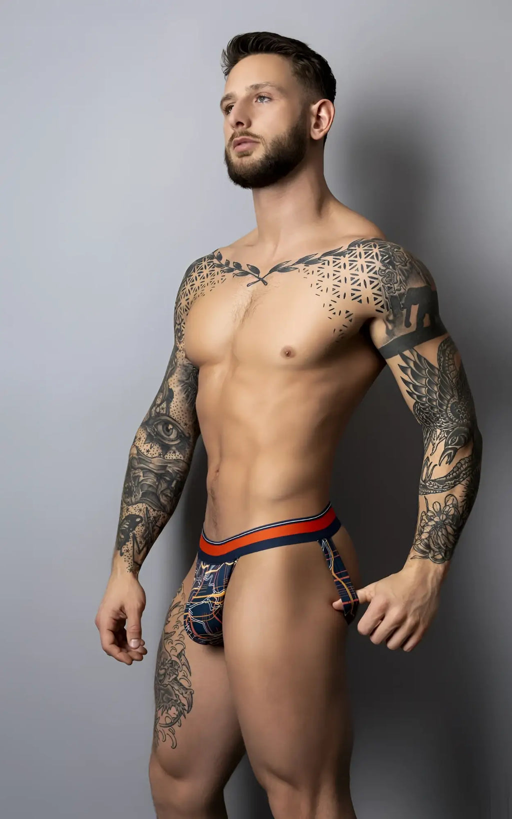 Men’s briefs with blue and orange geometric pattern from male power soo cumfy jock in navy and orange colors