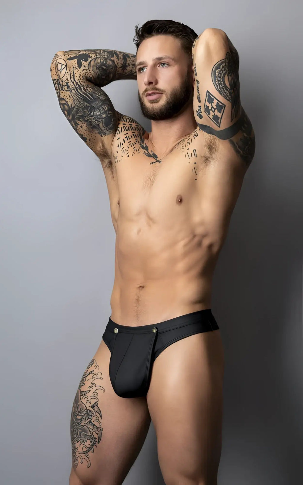 Male power 410-298 oh snap snap off thong in black sleek form-fitting men’s briefs with metallic button waistband detail