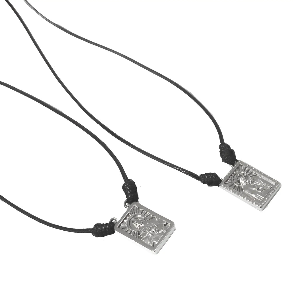 Silver rectangular male scapular pendant with engraved figure and beaded border on black cord necklace