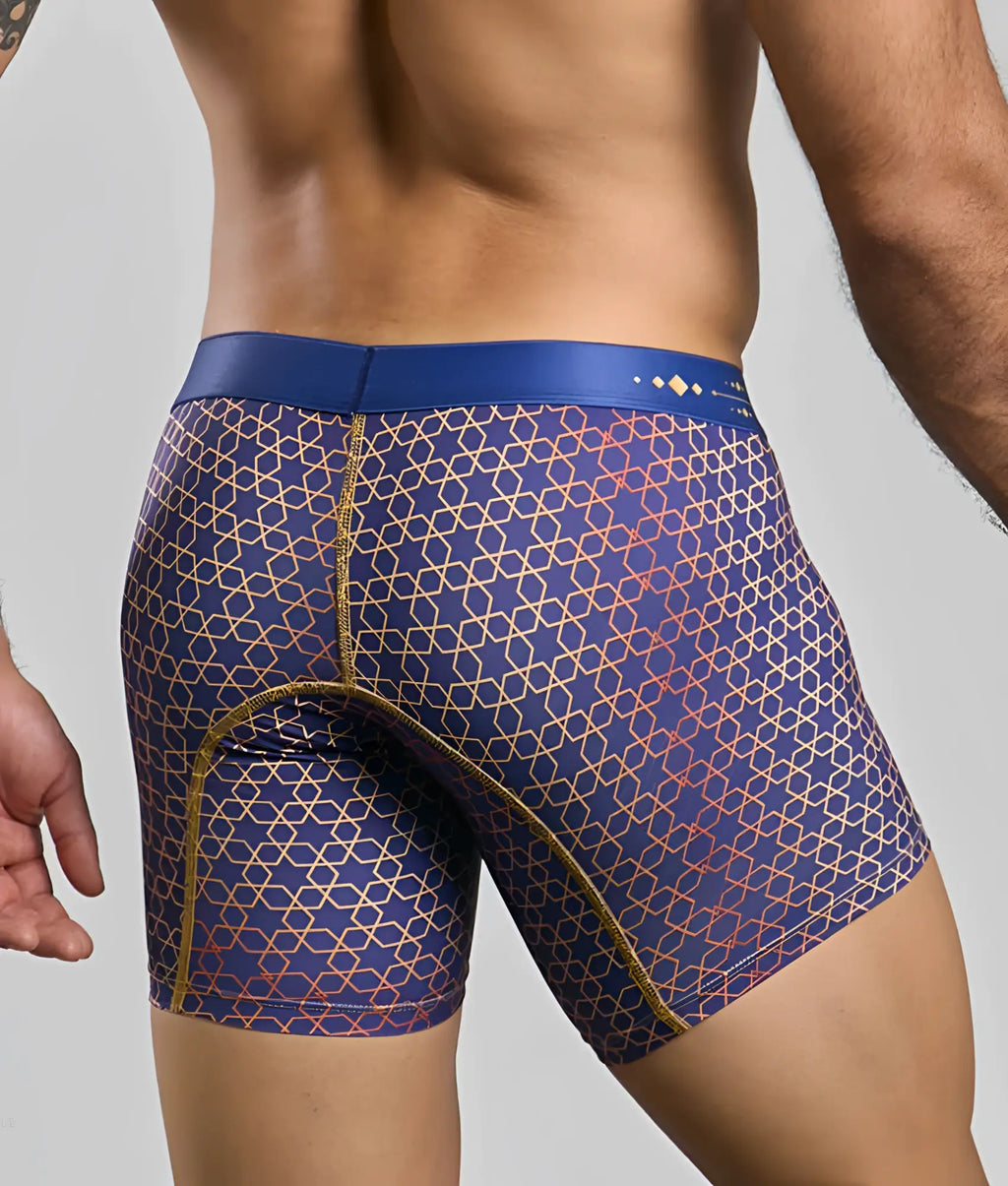 MaleBasics boxer brief hipster in blue with geometric gold and red pattern and matching blue waistband visible from the front