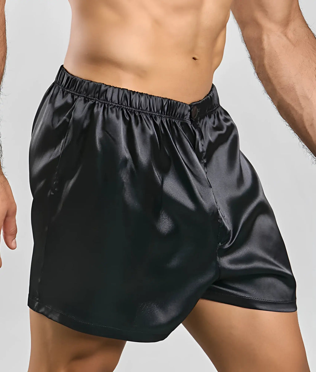 Black satin Malebasics shorts with elastic waistband and subtle button closure for comfortable wear