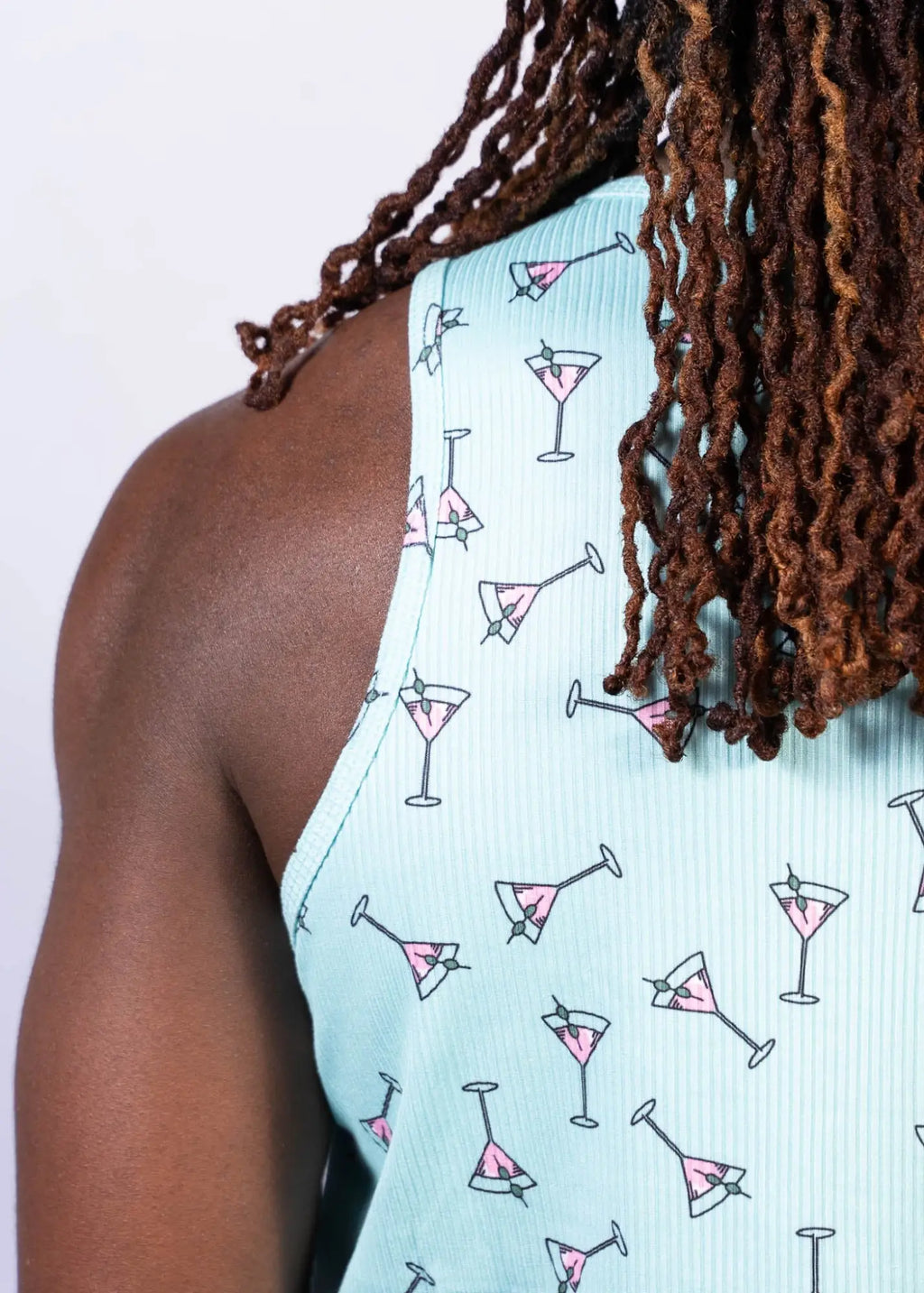Light blue ribbed tank top with playful pink martini glasses outlined in black called martini print tank