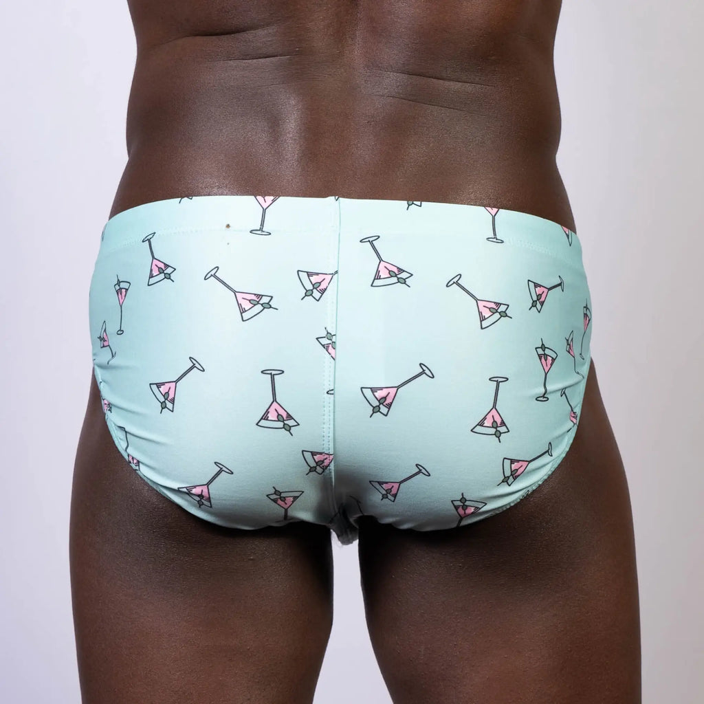 Light blue martini swim brief with pink martini glass pattern designed for stylish beachwear and poolside use