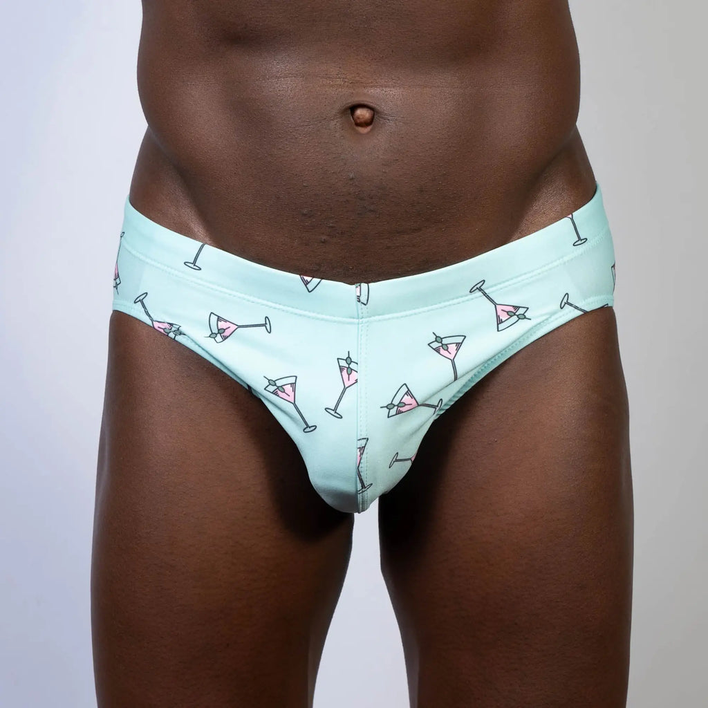 Mint green martini swim brief with playful pink martini glass pattern outlined in black perfect for swimwear