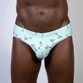Mint green martini swim brief with playful pink martini glass pattern outlined in black perfect for swimwear