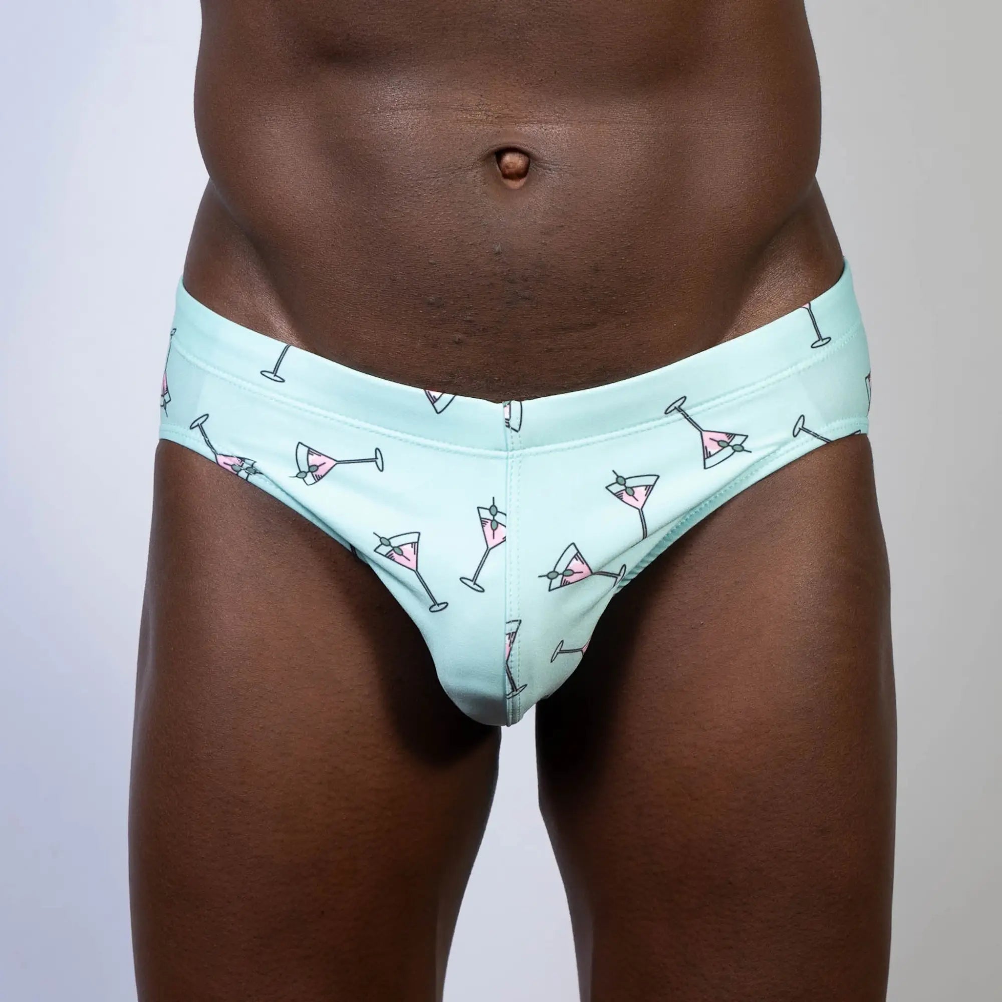 Mint green martini swim brief with playful pink martini glass pattern outlined in black perfect for swimwear