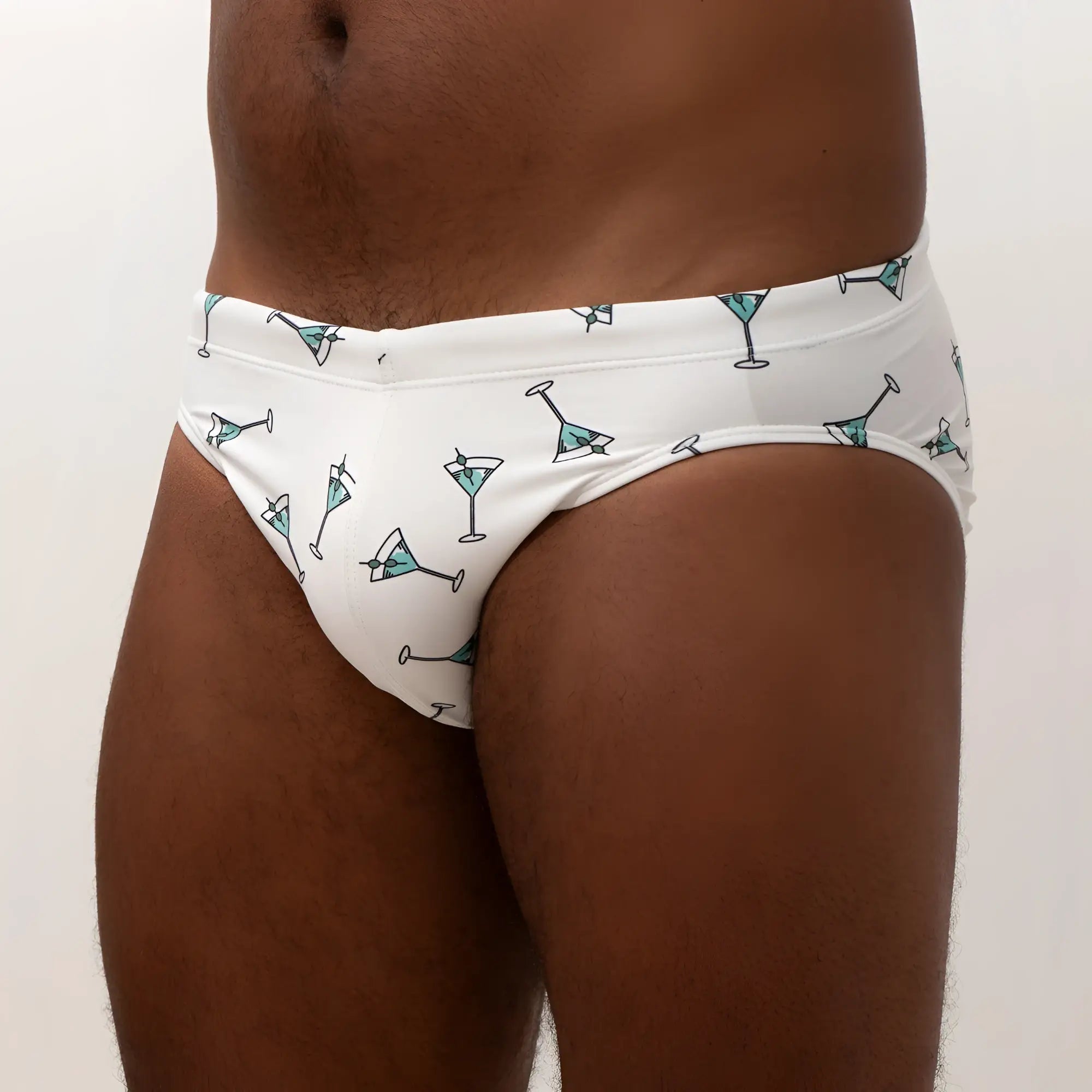 White martini swim brief featuring teal martini glass pattern with black outlines for stylish swimwear use