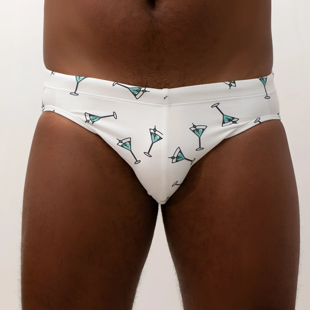White martini swim brief with playful teal glass pattern and black outlines perfect for swimwear and beachwear