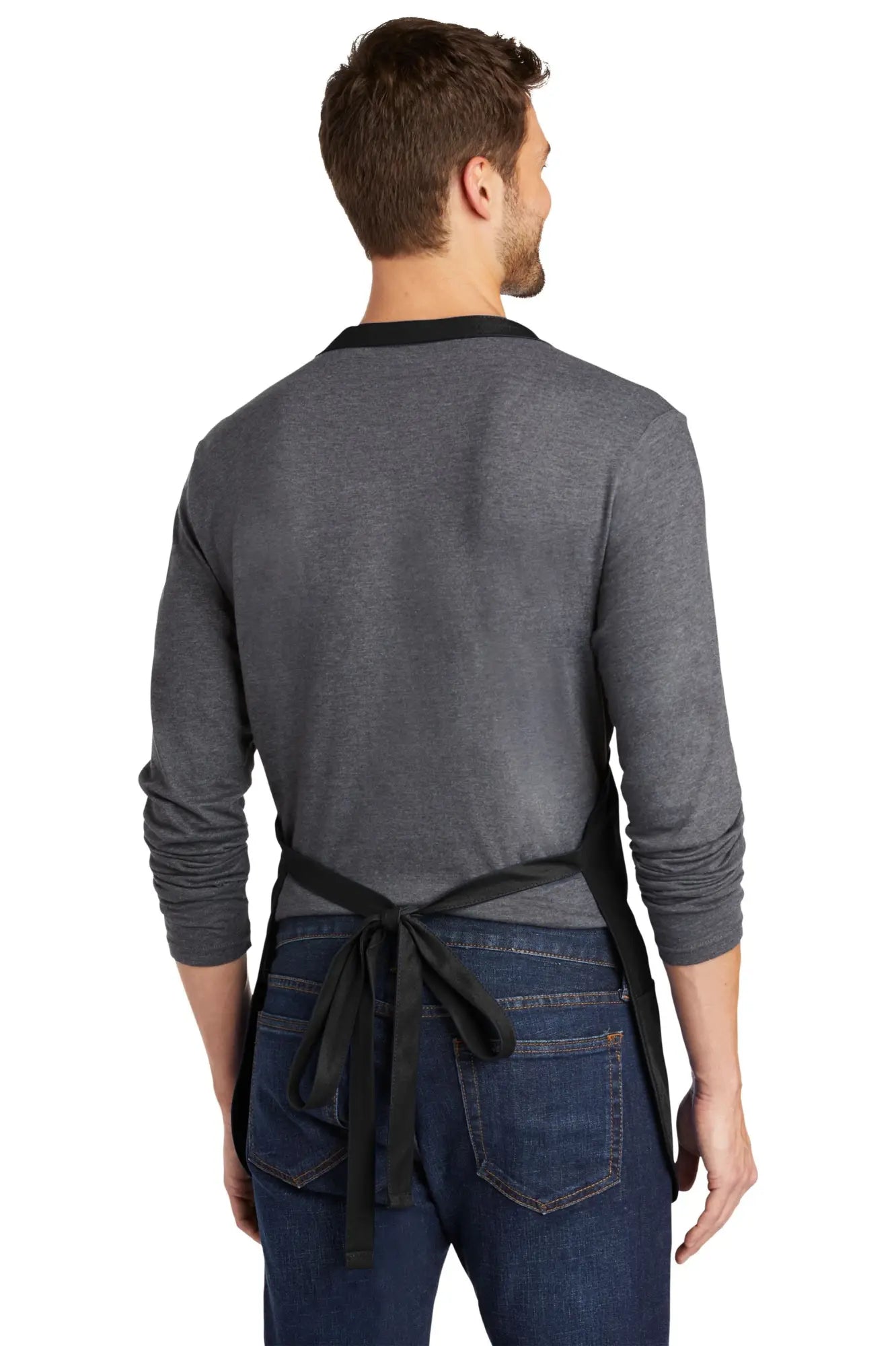 Masc4Snacks apron black simple tied waistband worn over gray long-sleeved shirt and blue jeans