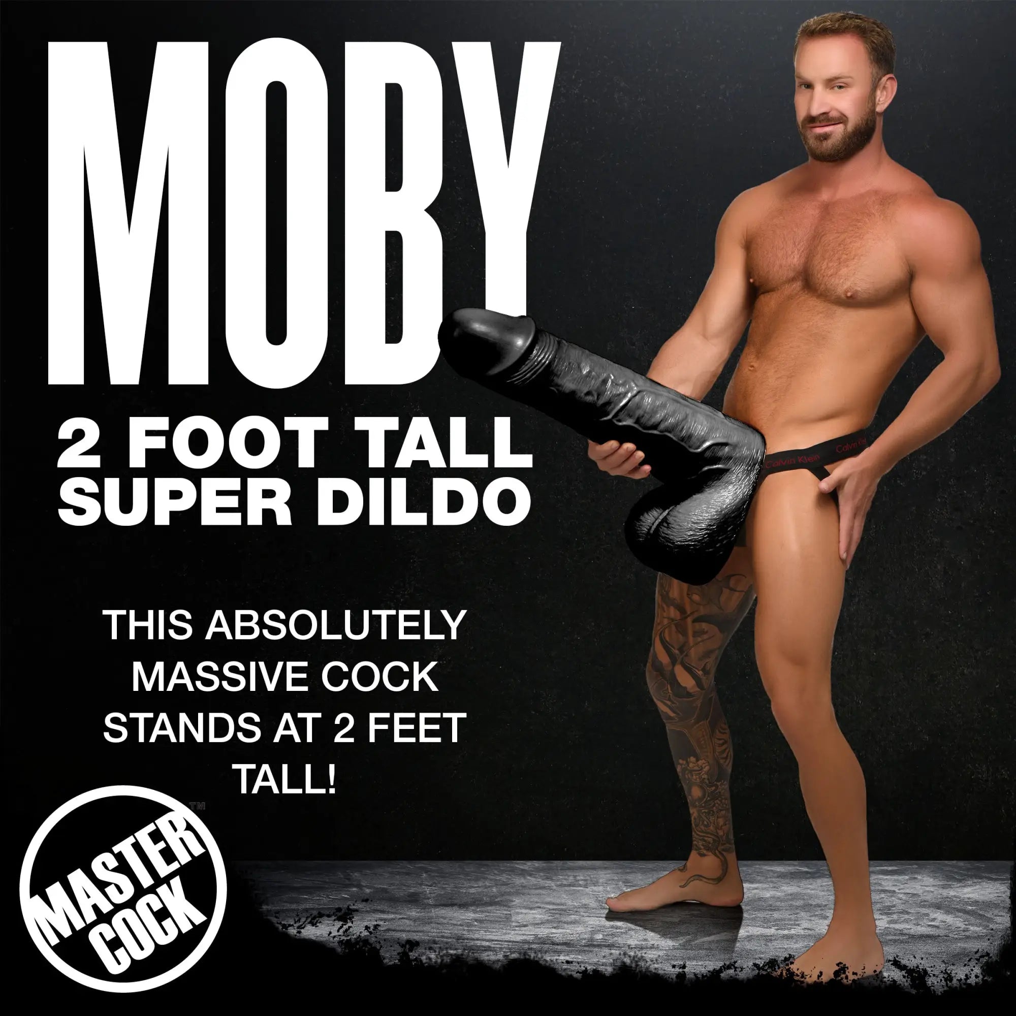Master Cock Black Moby: A man displays a massive 2-foot tall black, textured super dildo in a black background studio.