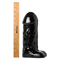 Master Cock The Cyclops Cock: A glossy black, textured phallic-shaped toy next to a 12-inch wooden ruler.
