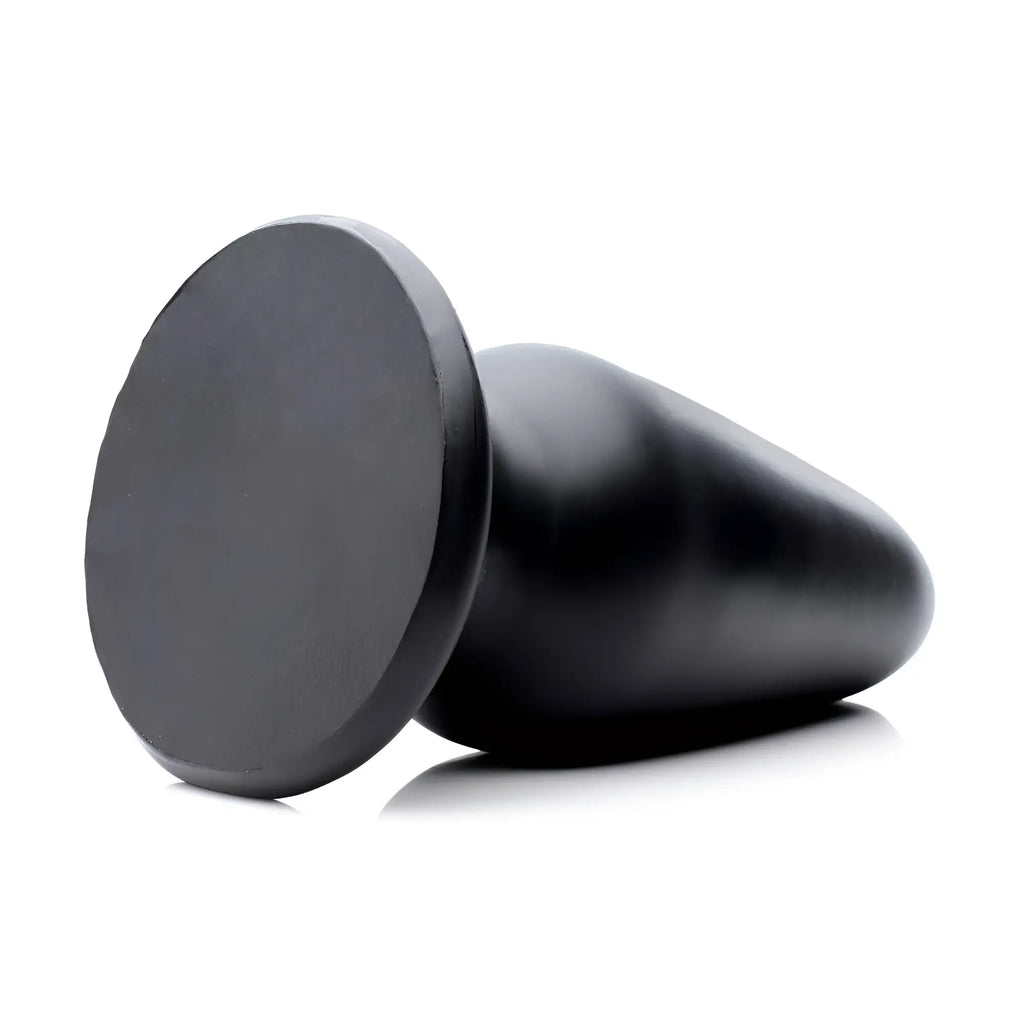 Master Cock Gigantor XXXL black, tapered butt plug with a flat, circular base, set against a white background.