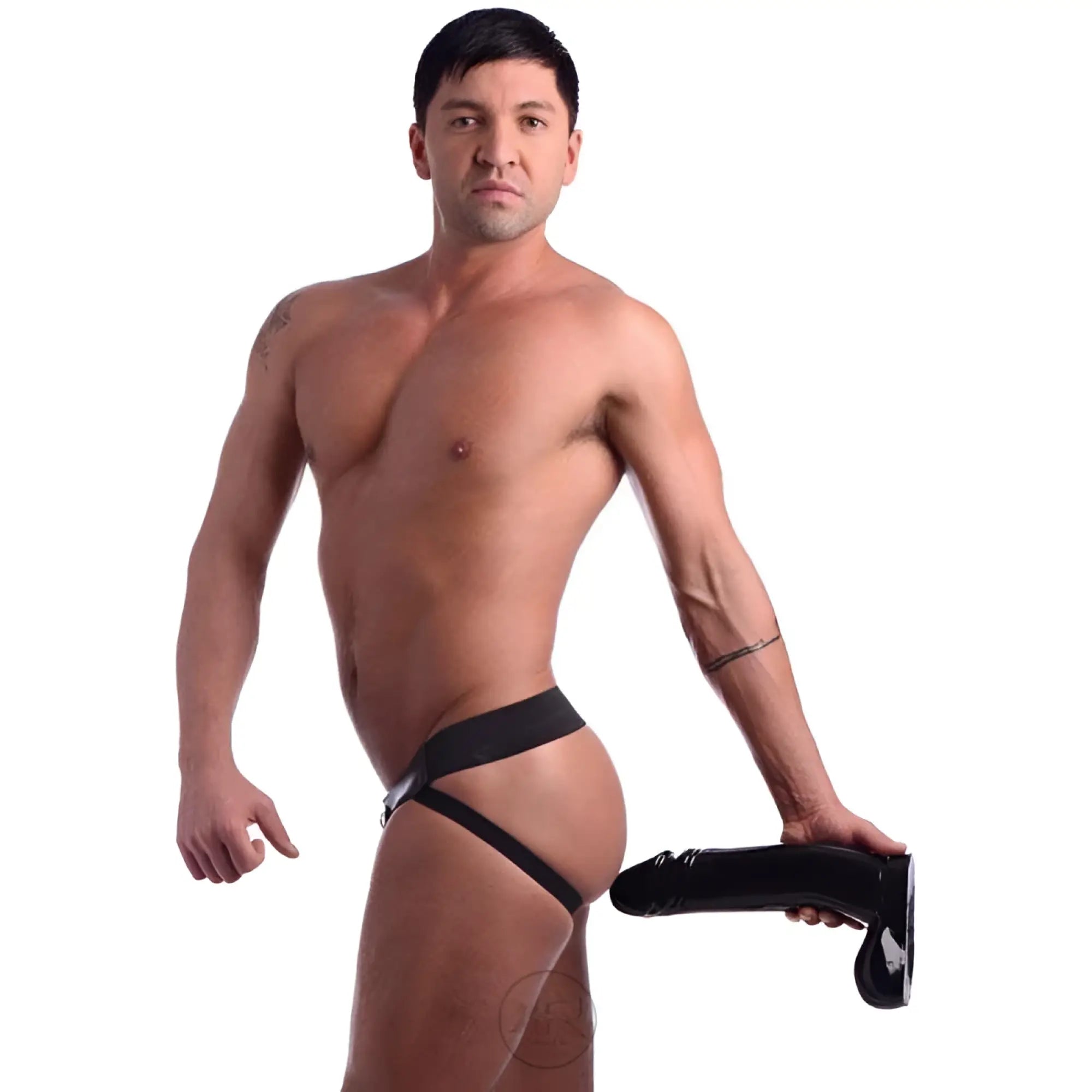 A muscular man wearing a black jockstrap harness holding a large, black Master Cock The Immense Ivan dildo.