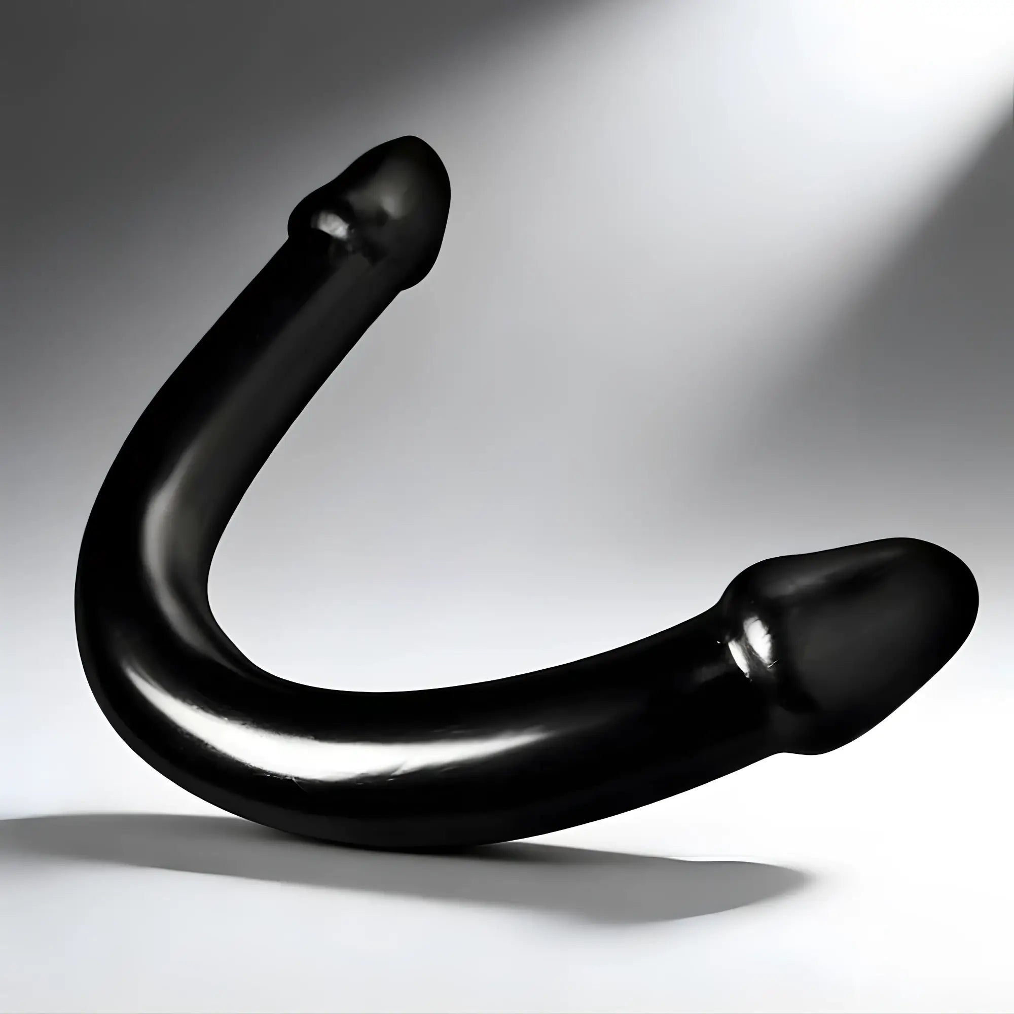 Master Cock The Python XL: A smooth, black, U-shaped double-ended toy against a white background.