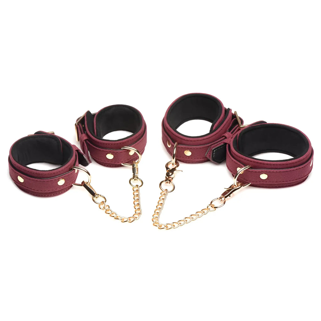 Master Series 6-piece burgundy velvet bondage cuffs with gold-tone hardware and connecting chains on a white background.