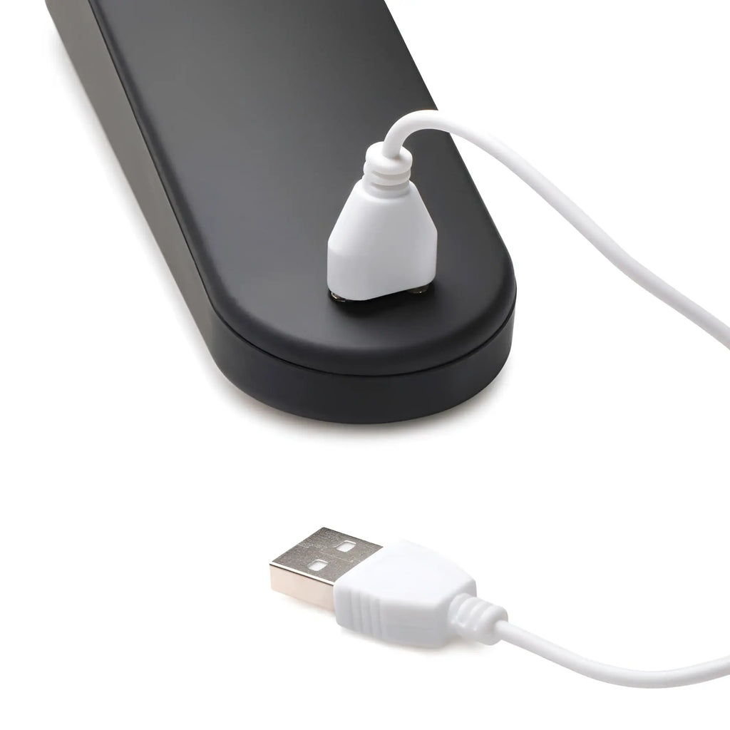 Master Series 72X Silicone Heating Wand Massager connected to a white USB charging cable on a white background.
