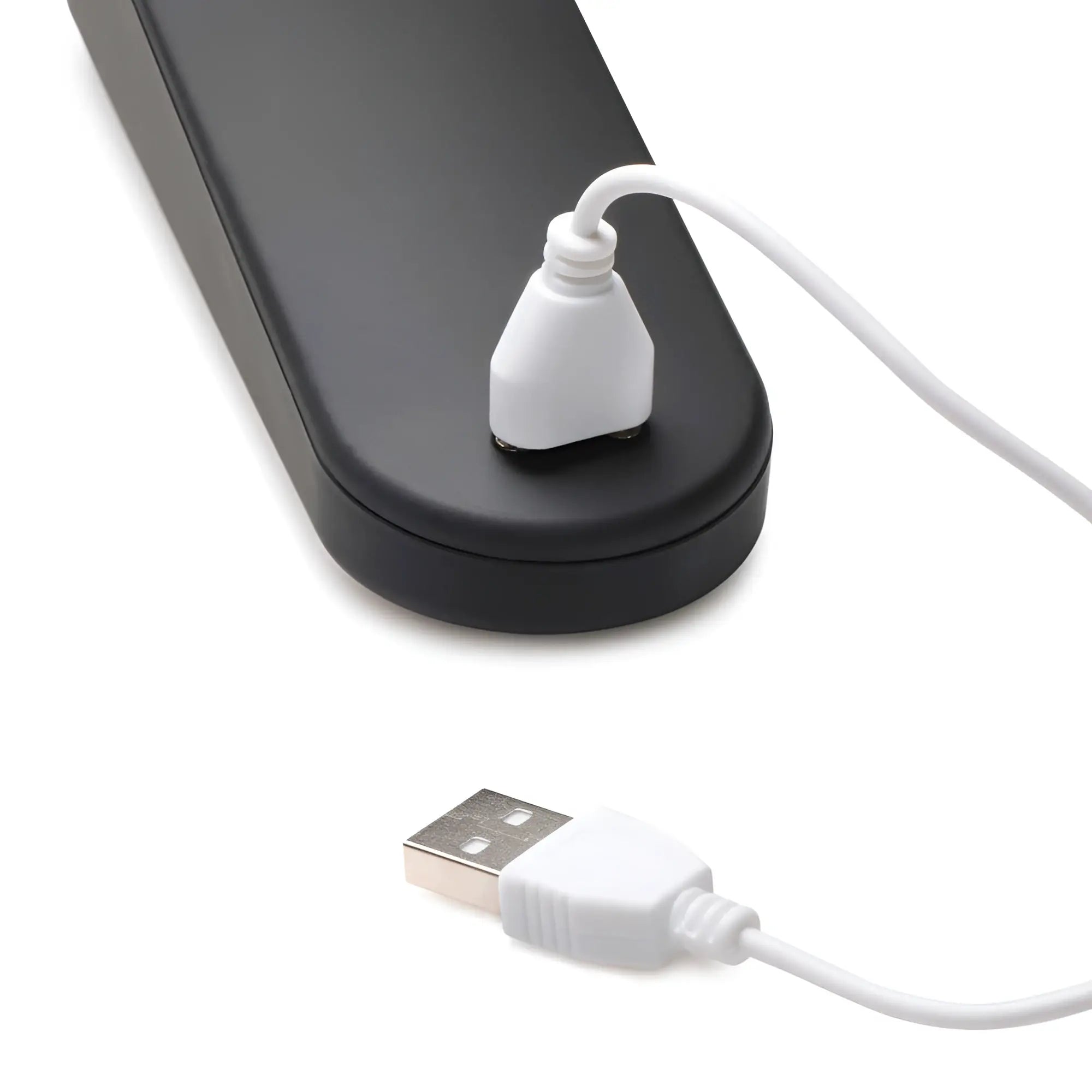 Master Series 72X Silicone Heating Wand Massager connected to a white USB charging cable on a white background.