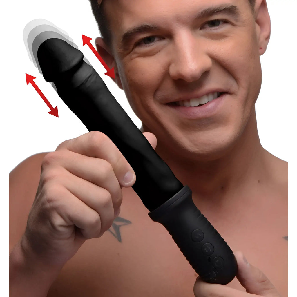 Man holding a black Master Series 8X Auto Pounder dildo with a handle, indicating thrusting motion with red arrows.