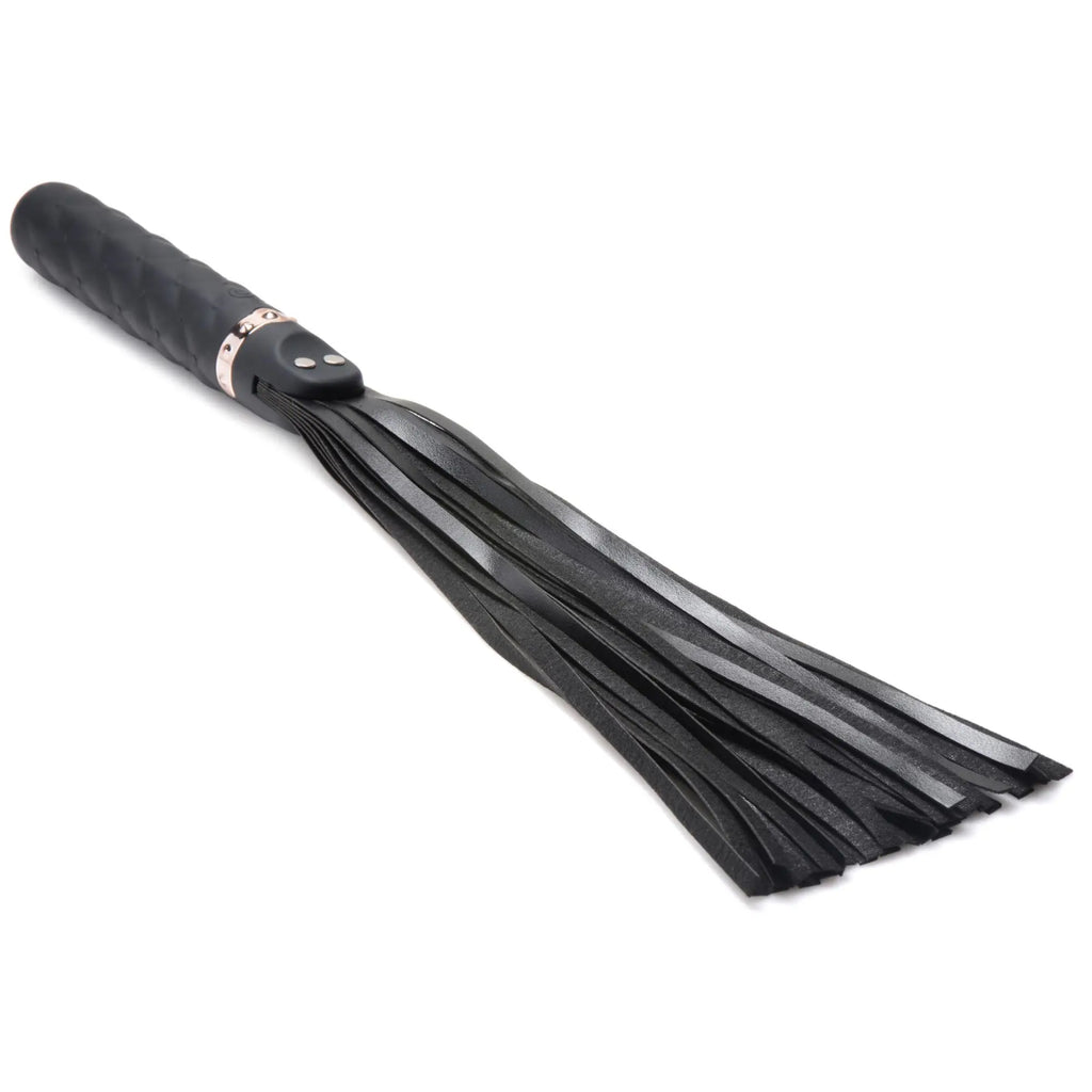 Master Series 9X black silicone vibrating flogger with textured handle and rose gold accents, isolated on white.