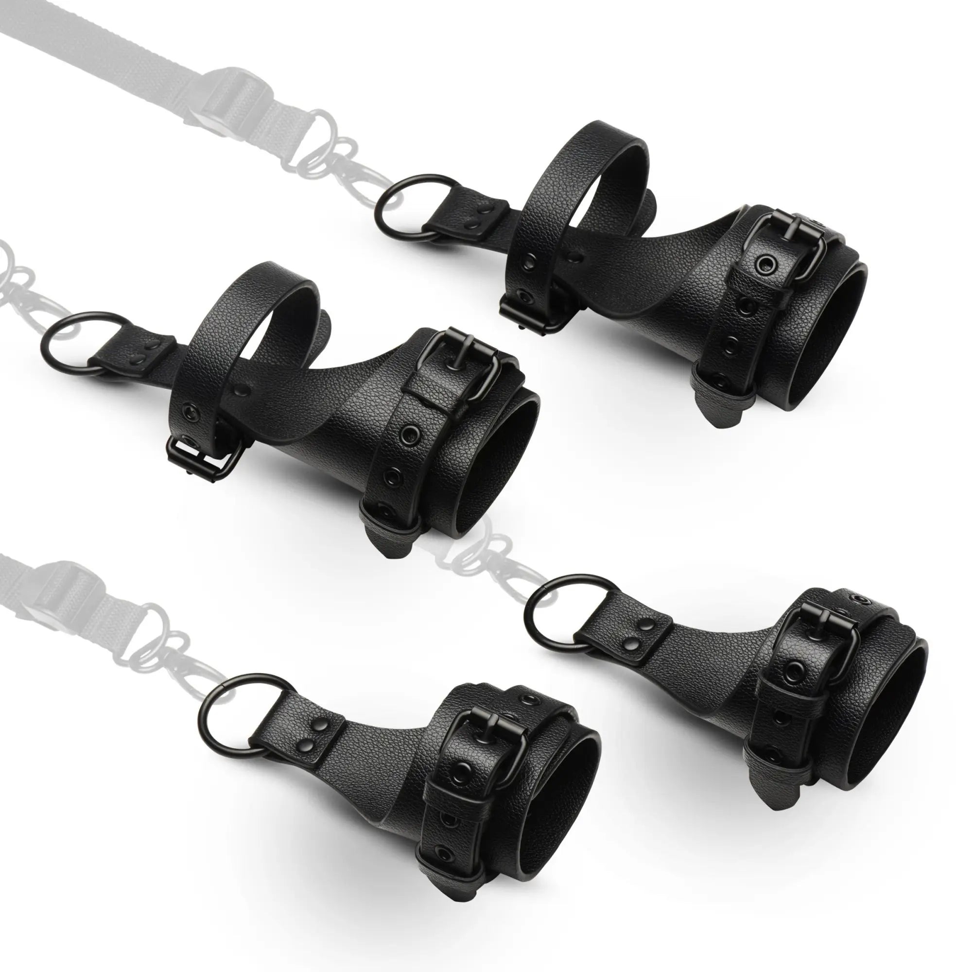 Master Series All Access Bed Restraint Kit: Four black textured faux leather cuffs with buckles and metal D-rings.