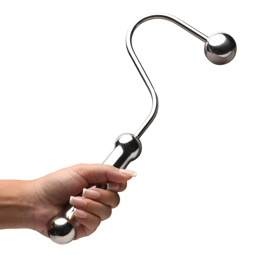 A hand holds a polished silver, curved Master Series Anal Hook with a spherical tip and ergonomic handle.
