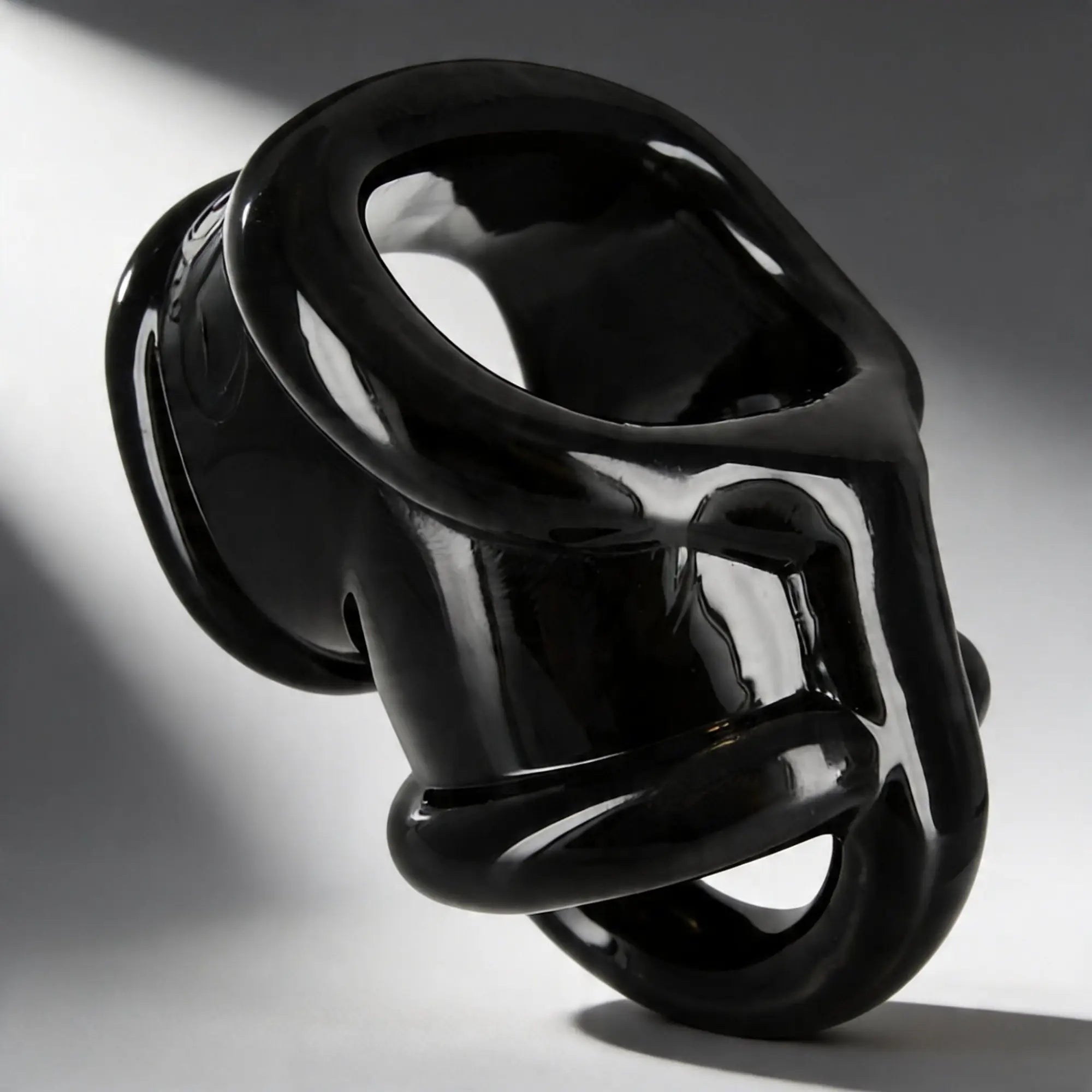 Master Series Annex Erection Enhancer: a glossy, black, sculptural silicone ring with a modern, ergonomic design.