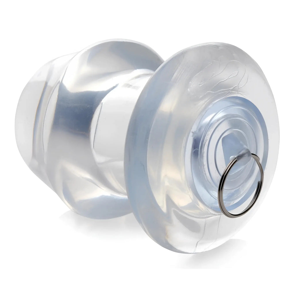 Master Series Ass Bung: A clear, hollow silicone anal dilator featuring a flared base and a small metal pull ring.