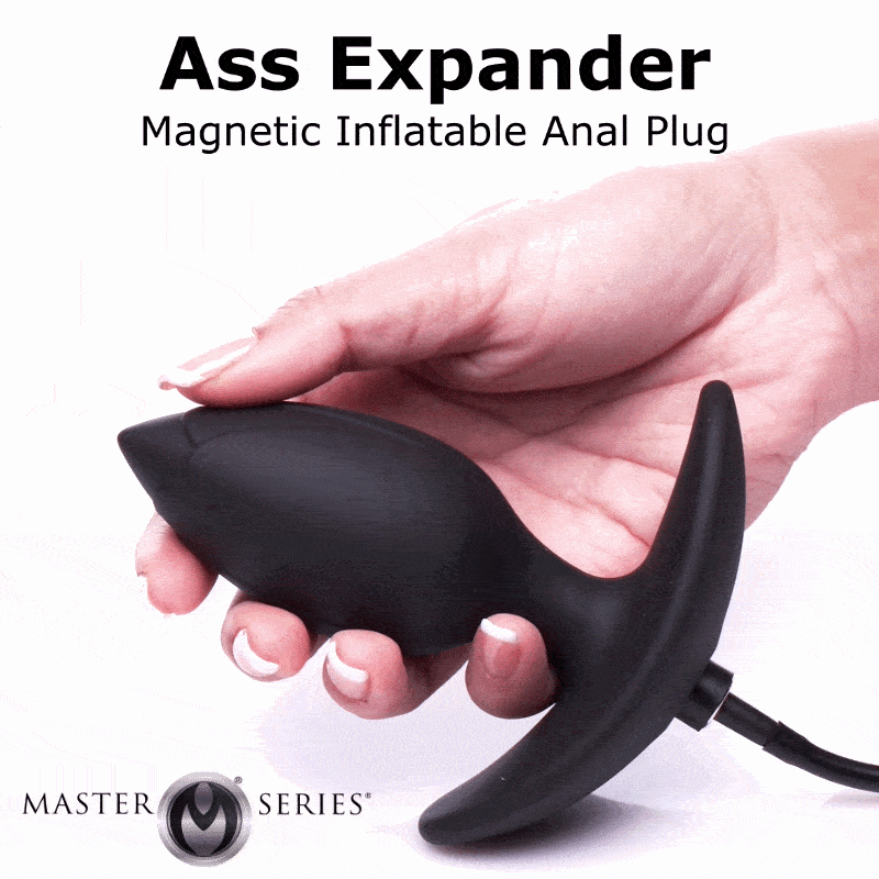 A hand holds a matte black Master Series magnetic inflatable anal plug against a white background.