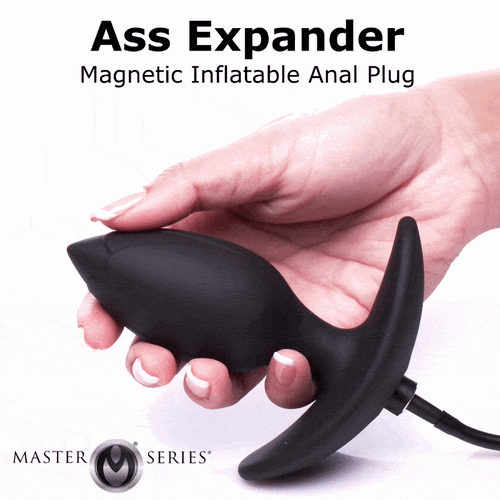 A hand holds a matte black Master Series magnetic inflatable anal plug against a white background.