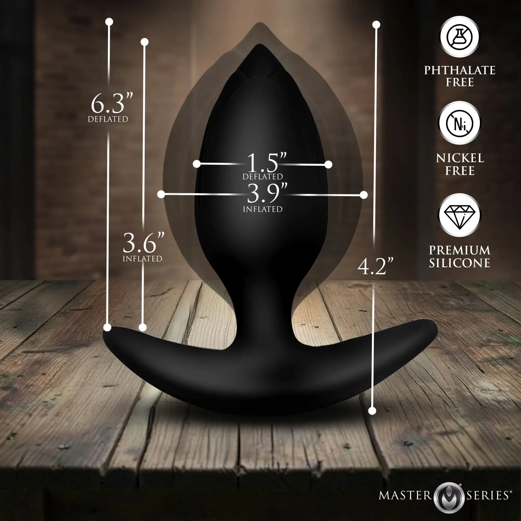 Master Series black silicone inflatable anal plug showing size dimensions in deflated and inflated states on wood table.