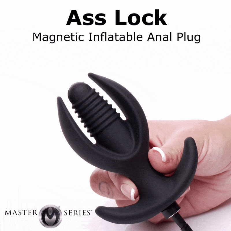 Hand holding a black Master Series Ass Lock magnetic inflatable anal plug with a ribbed, multi-pronged anchor design.